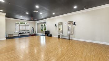 The multipurpose room has a hardwood floor and a black ceiling and a